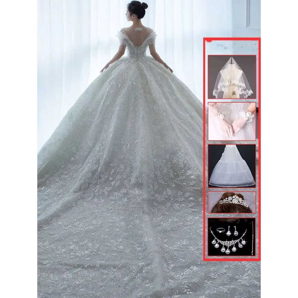 Off shoulder lace wedding dress in white featuring a voluminous skirt and delicate lace detailing perfect for brides