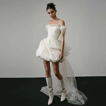 Off-shoulder tulle white wedding dress with structured bodice and voluminous skirt featuring an elegant train