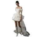 Off-shoulder tulle white wedding dress with structured bodice and asymmetrical train featuring a voluminous skirt