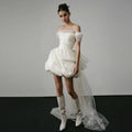 Off-shoulder tulle white mini dress with puffed skirt and sheer trailing overlay white wedding dress with train
