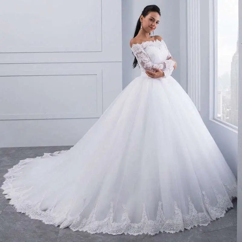 A white off-the-shoulder bridal wedding lace gown with long lace sleeves and a voluminous tulle skirt with floral embroidery