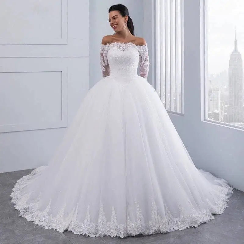 White off-the-shoulder bridal wedding lace gown with long sleeves and voluminous tulle skirt for elegant weddings
