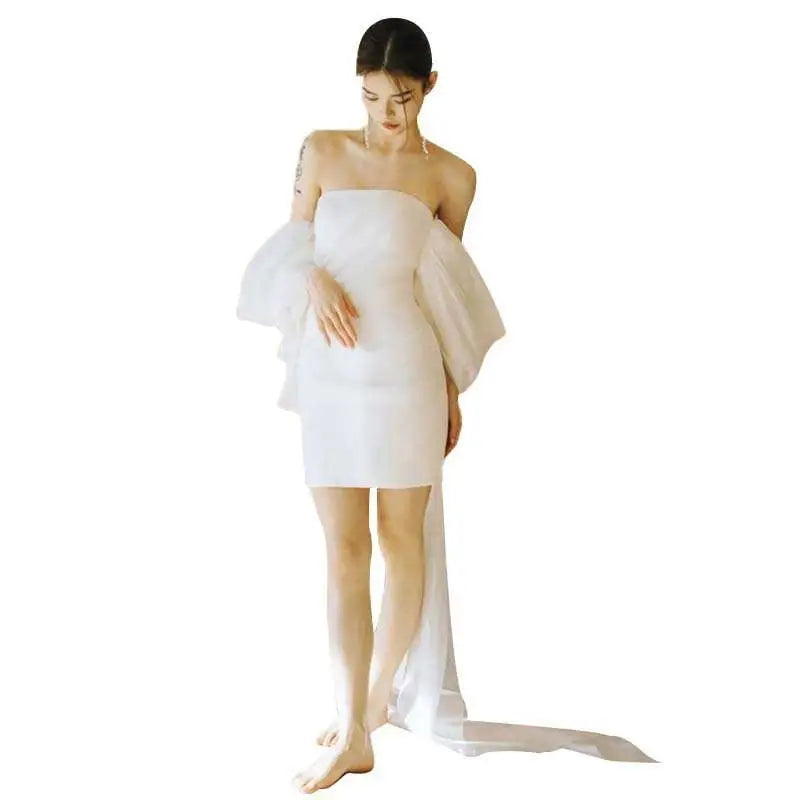 White off the shoulder mini wedding dress with sheer ruffled sleeves and flowing train for small light wedding events