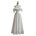 Off the shoulder satin light wedding dress in white with puffed sleeves and delicate tie details in satin material