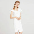 A sleek white off the shoulder split white dress featuring a fitted silhouette and side slit midi length
