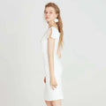 White off the shoulder split white dress with back cutout and short flutter sleeves in a fitted silhouette midi style