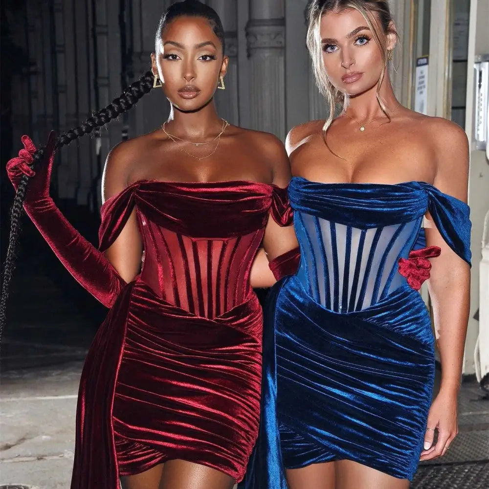 Two women wear off the shoulder velvet sexy evening mini dresses in deep red and royal blue colors