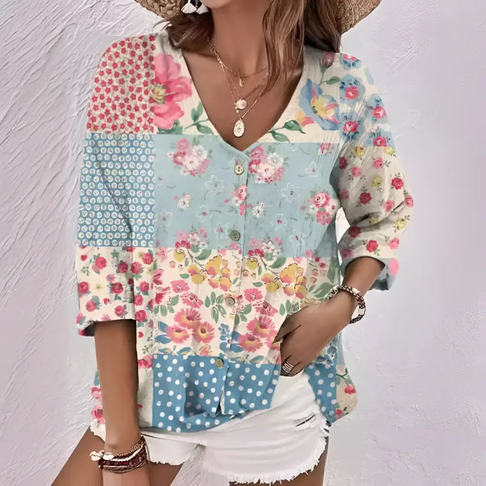 Oil painting printed floral v-neck blouse in pastel pink blue and cream polyester fiber with button front and three quarter sleeves