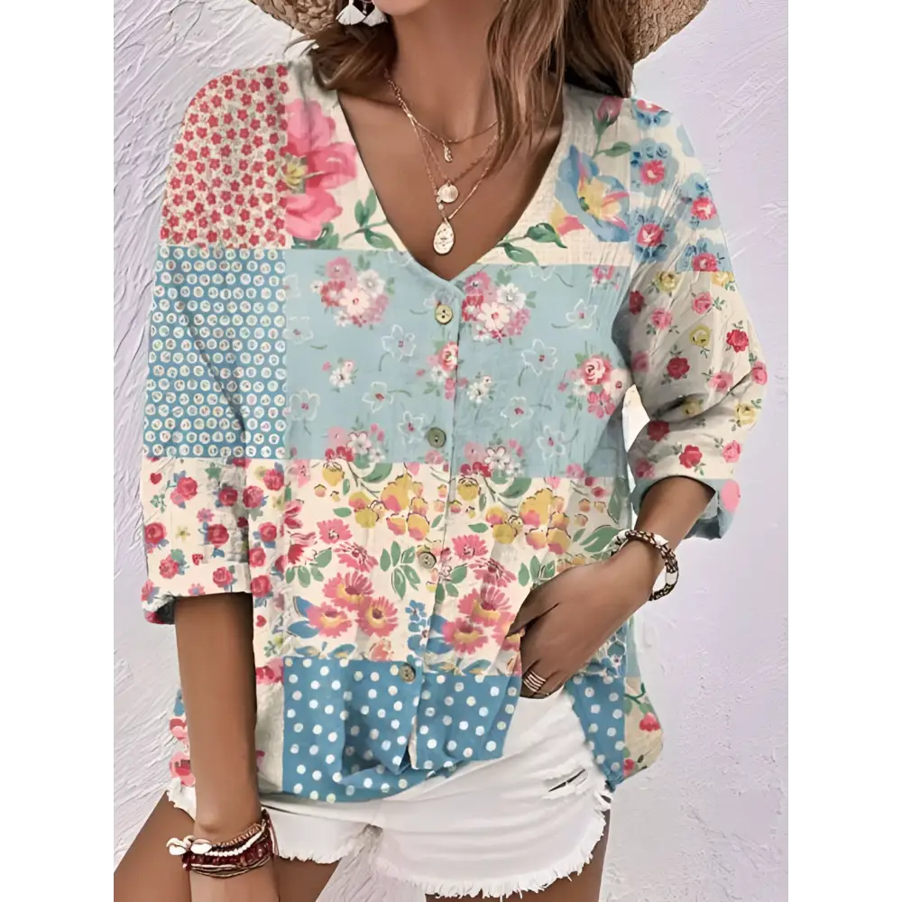 Oil painting printed floral v-neck blouse in pastel pink blue and cream polyester fiber with button front and three quarter sleeves