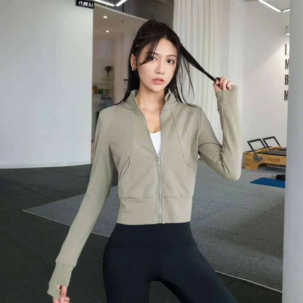Olive green cropped running sport coat with long sleeves and sleek zip-up design from Royale Essence Lux