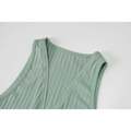 Back view of a mint green ribbed knitted women sleeveless top with a silver zipper for an olive green stripe dress