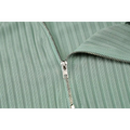 A mint green ribbed fabric zipper with silver metal pull tab on the back of an olive green stripe knitted women sleeveless dress