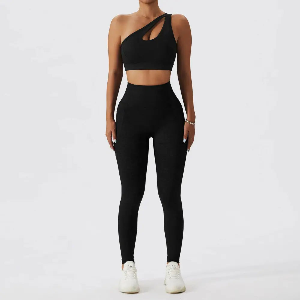 Black one-shoulder bra fitness suit with cutout detail and matching high-waisted leggings for olive green yoga sessions