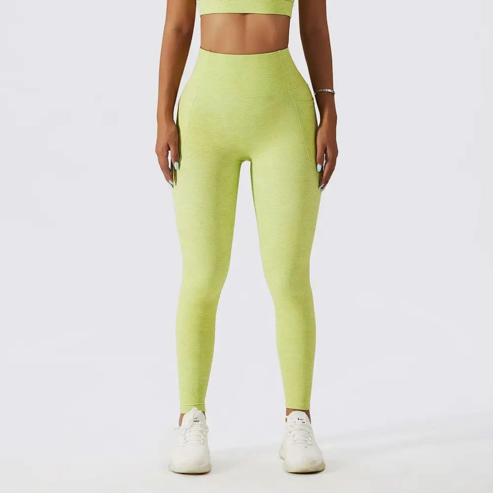Olive green yoga bra fitness suit with lime green high-waisted leggings featuring textured stretchy fabric and side pockets