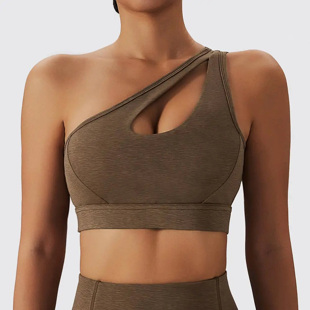 A sleek olive green yoga bra fitness suit featuring a one-shoulder asymmetrical cutout and textured fabric