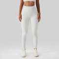 White high-waisted leggings with a textured form-fitting design complementing olive green yoga bra fitness suit with pockets