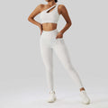 White one-shoulder crop top with cutout detail and matching high-waisted leggings in olive green yoga bra fitness suit with pockets