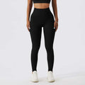 Black high-waisted leggings with smooth form-fitting material and subtle side pockets paired with olive green yoga bra fitness suit