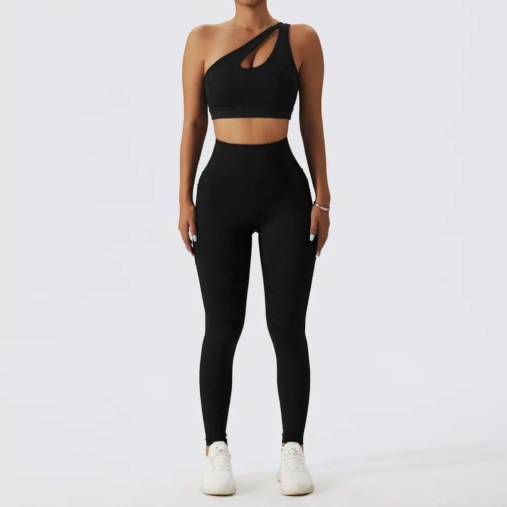 Black one-shoulder bra fitness suit with cutout detail paired with high-waisted leggings in olive green yoga style