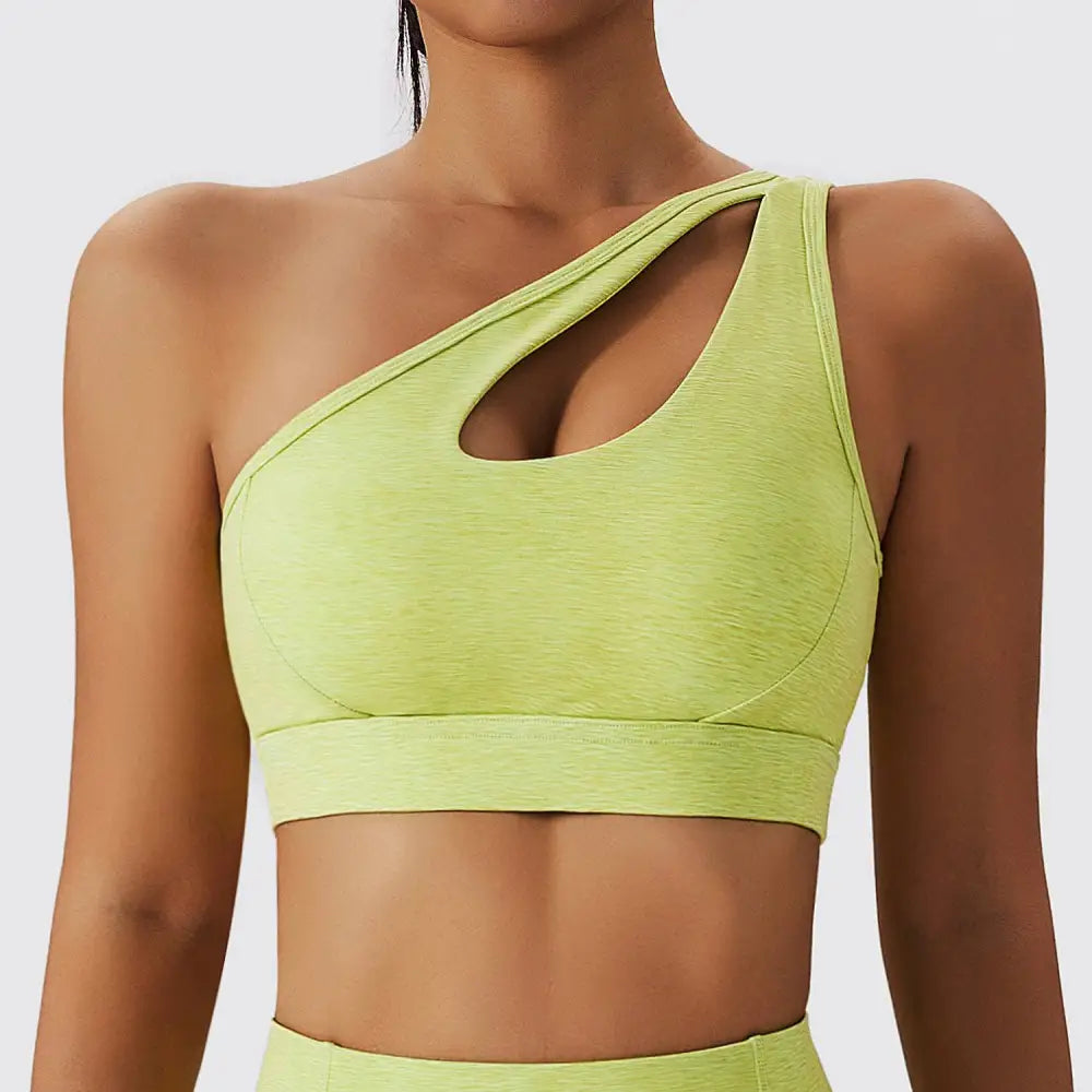 A vibrant olive green yoga bra fitness suit with one-shoulder cutout design seamless stretchy fabric pockets