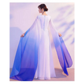 A flowing chiffon ombre cape blue with white to blue gradient drapes over an evening floral choral dress for red song competition