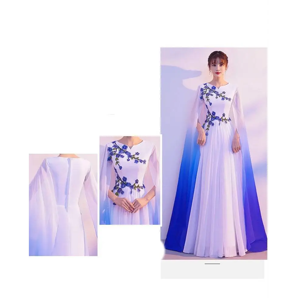 A flowing white floral choral dress with blue embroidery and an ombre cape blue for red song competition events