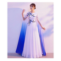 White flowing floral choral dress with blue embroidery and ombre cape for red song competition performance