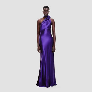 A sleek one shoulder fitted high waist purple satin rose gown with a rose accent at the neckline