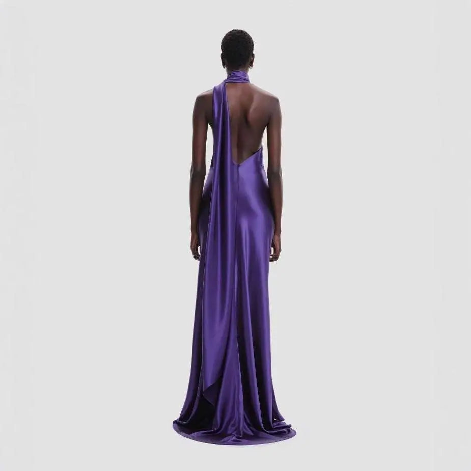 A sleek fitted high waist purple satin rose gown with a one-shoulder design and an open back view