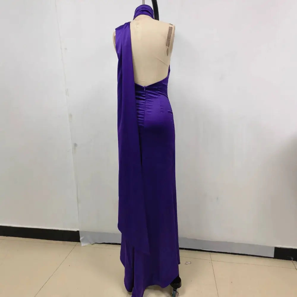 A fitted high waist deep purple satin rose gown with one shoulder design and open back shown from the back side