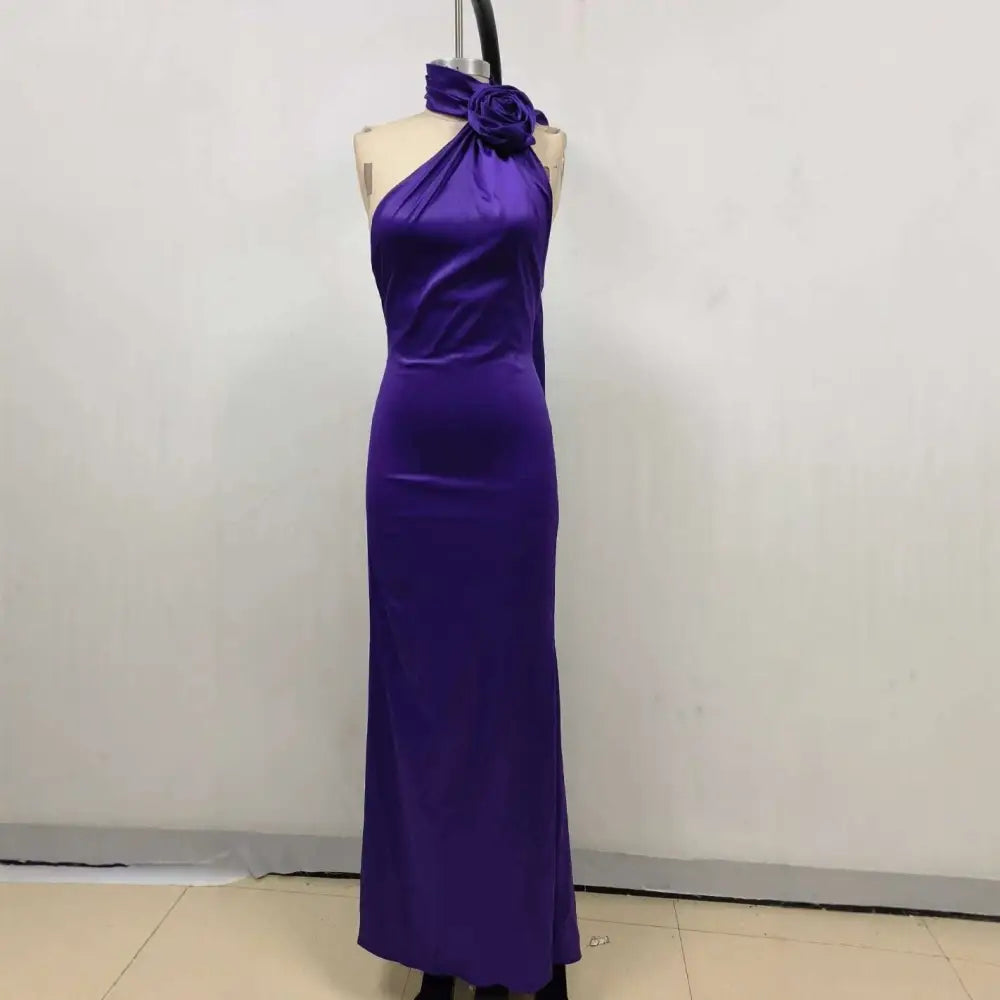 A sleek one shoulder fitted high waist purple satin rose gown with a rose accent at the neckline