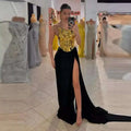 A one-shoulder slit mop black dress two-piece set with a shimmering gold bodice and flowing black satin skirt