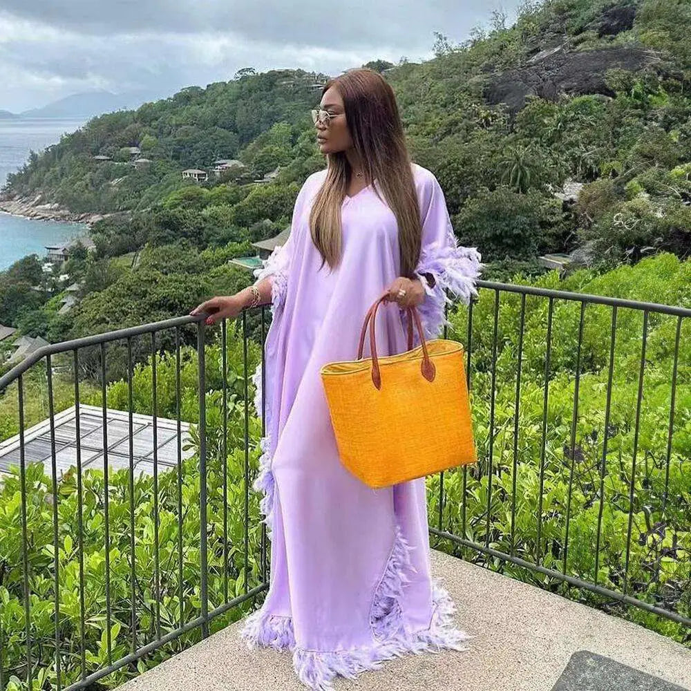 Vibrant orange woven tote bag with brown leather handles complements the orange feathered loose dress luxury robe collection