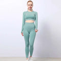A sleek mint-green two-piece seamless yoga set with jacquard texture featuring a long-sleeved crop top and leggings