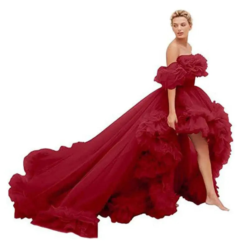 A voluminous off-the-shoulder red high low gown with layered ruffles for luxury women’s fashion and beaded evening