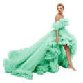 A mint green luxury women’s fashion off-the-shoulder layered tulle high low gown with dramatic ruffled skirt and train
