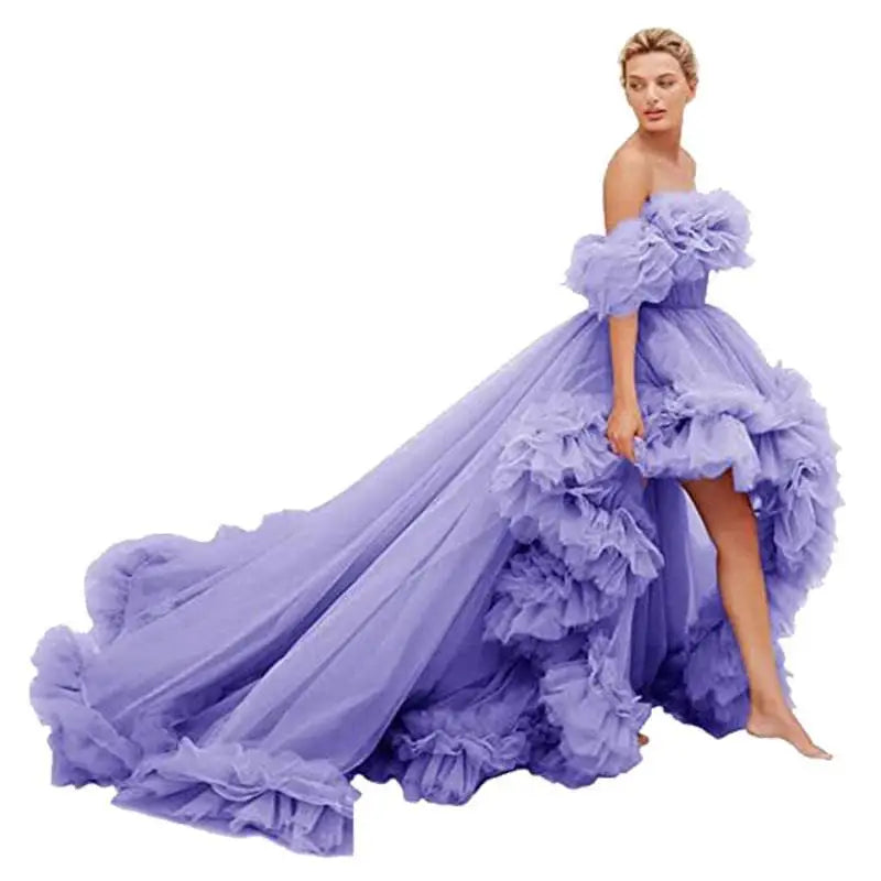 A flowing lavender tulle luxury women’s fashion high low gown with ruffled off the shoulder bodice and layered skirt