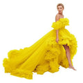A vibrant yellow off-the-shoulder luxury women’s fashion high low gown with voluminous ruffles and flowing train