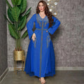 A vibrant royal blue middle east diamond beaded dress featuring intricate gold embroidery on neckline and panels