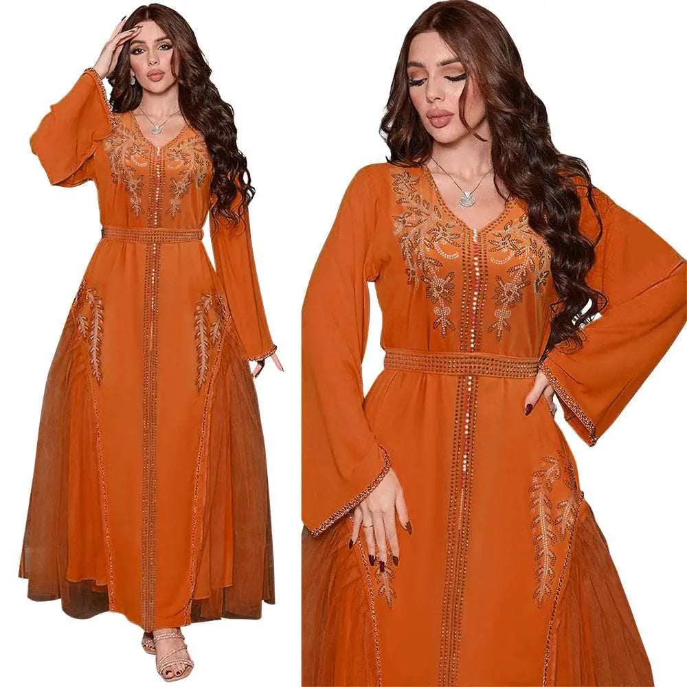 A flowing orange middle east diamond beaded dress with intricate gold embroidery and a matching belt