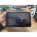 Black original car exterior tablet with cracked screen held in hand for screen replacement touch use