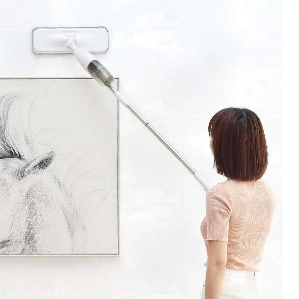White rectangular wall-mounted xiaomi deerma spray mop with silver telescopic handle and transparent spray bottle section