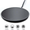 Black circular electric mug cup warmer with sleek ceramic surface and subtle indicator light for tea and coffee use