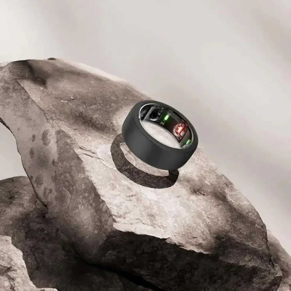 Black oura ring 3rd gen with sleek silicone protector case and illuminated red and green display lights