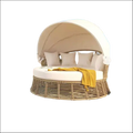 Beige outdoor patio rattan round daybed with canopy and white cushions accented by yellow throw blanket sofa bed style