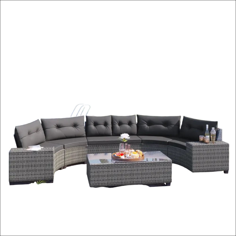 Curved outdoor wicker round sofa set with dark gray tufted cushions, woven wicker frame, and matching tables