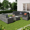 Gray woven wicker round sofa set with dark gray cushions and decorative throw pillows for outdoor use