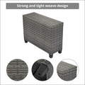 Gray woven wicker storage bench with black plastic feet part of an outdoor wicker round sofa set