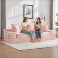 Oversized boneless four seats sofa in pink corduroy with ribbed texture and built-in storage pockets