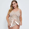 Delicate beige oversized lace bodysuit with floral pattern and satin ribbon belt tied in a bow at the waist